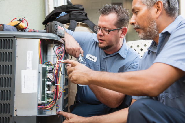 Two service technicians performing preventative maintenance