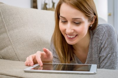 woman laying on couch smiling