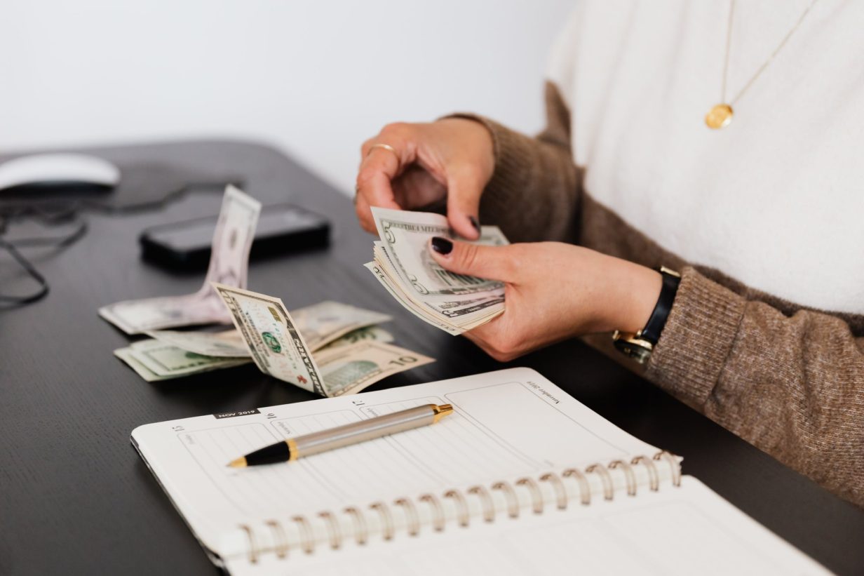 women counting bills while doing her finances