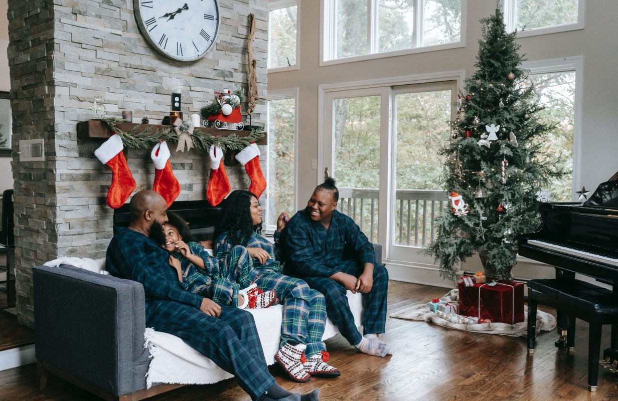 happy family sitting in living room in winter
